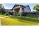 Beautiful home with lush landscaping, stone accents, and a welcoming front porch, perfect for relaxing outdoors at 4565 N Point Ridge Rd, Buckeye, AZ 85396