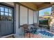 Inviting covered front porch with seating area, perfect for relaxing and enjoying the neighborhood views at 4565 N Point Ridge Rd, Buckeye, AZ 85396