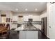 Modern kitchen with granite countertops, stainless steel appliances, and a large island for food preparation at 4565 N Point Ridge Rd, Buckeye, AZ 85396