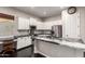 Bright kitchen with white cabinets, granite countertops, and stainless steel appliances, perfect for cooking at 4565 N Point Ridge Rd, Buckeye, AZ 85396