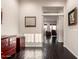Hallway features lustrous wood floors, decorative furniture, and windowed doorway into living area at 4565 N Point Ridge Rd, Buckeye, AZ 85396