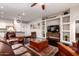 Inviting living room with hardwood floors, built-in shelving, and comfortable seating for entertaining guests at 4565 N Point Ridge Rd, Buckeye, AZ 85396