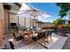 Staged patio area features dining set, grill, and view of the sparkling pool at 4565 N Point Ridge Rd, Buckeye, AZ 85396