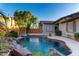 Stunning outdoor pool showcasing rock features, desert landscaping, and inviting design at 4565 N Point Ridge Rd, Buckeye, AZ 85396