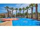 Community splash pad with spraying features and colorful surfaces, surrounded by palm trees at 4565 N Point Ridge Rd, Buckeye, AZ 85396