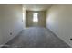 A light-filled bedroom awaits your personal touch to transform it into a cozy space at 47214 W Cansados Rd, Maricopa, AZ 85139