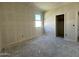 A bright bedroom showcases a window and a doorway, awaiting personalized touches at 47214 W Cansados Rd, Maricopa, AZ 85139