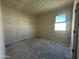 A bright room features a window and a doorway, awaiting personalization at 47214 W Cansados Rd, Maricopa, AZ 85139