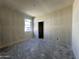 A room under construction showcases a window and doorway providing ample natural light and access at 47214 W Cansados Rd, Maricopa, AZ 85139