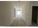 A long hallway with natural light from windows and open doorways provides a spacious feel to the interior at 47214 W Cansados Rd, Maricopa, AZ 85139