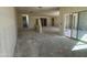 This expansive living area features multiple entry points and a sliding glass door for natural light at 47214 W Cansados Rd, Maricopa, AZ 85139