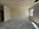 A spacious living room with a large window is ready for flooring and custom design at 47214 W Cansados Rd, Maricopa, AZ 85139
