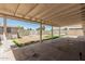 Covered patio area overlooking the backyard with fencing and a shed at 5022 W Pierson St, Phoenix, AZ 85031