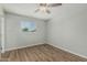 Bright bedroom with wood-style flooring, neutral paint and modern ceiling fan at 5022 W Pierson St, Phoenix, AZ 85031
