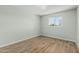 Bright bedroom featuring wood-look flooring and a window with a view of the outdoors at 5022 W Pierson St, Phoenix, AZ 85031