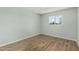 Bright bedroom featuring wood-look flooring and a window with a view of the outdoors at 5022 W Pierson St, Phoenix, AZ 85031