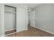 Bedroom featuring wood-look flooring, a closet, and a view into another room at 5022 W Pierson St, Phoenix, AZ 85031