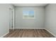 Bright bedroom with wood-style flooring, neutral paint and large window at 5022 W Pierson St, Phoenix, AZ 85031