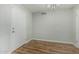 Hallway featuring modern wood-style floors, white baseboards and neutral paint at 5022 W Pierson St, Phoenix, AZ 85031