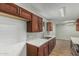 Spacious kitchen with stone countertops, mosaic backsplash, and wooden cabinets at 5022 W Pierson St, Phoenix, AZ 85031