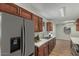Updated kitchen with stainless steel refrigerator, wood cabinets, tiled backsplash, and modern faucet at 5022 W Pierson St, Phoenix, AZ 85031