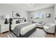 Stylish bedroom with a white brick wall, plush bed, gray accents, and modern artwork at 5022 W Pierson St, Phoenix, AZ 85031