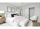 Cozy bedroom with a soft bed, white bench, and a well-organized closet with sliding doors at 5022 W Pierson St, Phoenix, AZ 85031