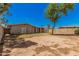 View of the home's back exterior with a spacious backyard at 5738 W Heatherbrae Dr, Phoenix, AZ 85031