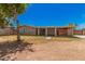 View of the home's back exterior with a spacious backyard at 5738 W Heatherbrae Dr, Phoenix, AZ 85031