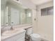 Bathroom with a toilet and shower with a sink and large mirror at 5738 W Heatherbrae Dr, Phoenix, AZ 85031