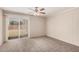 Bright and airy bedroom with carpet and sliding glass door to the yard at 5738 W Heatherbrae Dr, Phoenix, AZ 85031