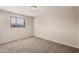 Neutral-toned bedroom with a window and plush carpet at 5738 W Heatherbrae Dr, Phoenix, AZ 85031