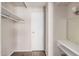 Walk in closet area with rod and shelving, with white door and vanity with mirror at 5738 W Heatherbrae Dr, Phoenix, AZ 85031