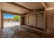 Empty open garage with exposed rafters and brick walls at 5738 W Heatherbrae Dr, Phoenix, AZ 85031
