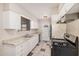 Galley style kitchen includes white cabinets and modern appliances at 5738 W Heatherbrae Dr, Phoenix, AZ 85031