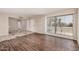 Spacious living room with wood laminate flooring and large window for lots of light at 5738 W Heatherbrae Dr, Phoenix, AZ 85031