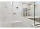 Modern shower features marble tile, a built-in seat, and glass enclosure at 5840 E Covey Ln, Phoenix, AZ 85054