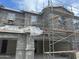 Two-story stucco home exterior under construction showcases a modern design with scaffolding, offering a glimpse of potential at 5840 E Covey Ln, Phoenix, AZ 85054