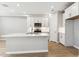 Modern kitchen featuring stainless steel appliances, white cabinets, a center island with a sink and tile backsplash at 5840 E Covey Ln, Phoenix, AZ 85054