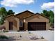 Charming one-story home with a two-car garage, desert landscaping and covered entry at 5840 W Coplen Farms Rd, Laveen, AZ 85339