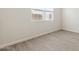 Neutral bedroom with tile floors, base trim, and a bright window with horizontal blinds at 5844 E Covey Ln, Phoenix, AZ 85054