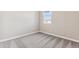 Empty bedroom with carpet, window and view of adjacent roof at 5844 E Covey Ln, Phoenix, AZ 85054