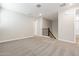 Neutral carpeted bonus room with stairs and several entry doors at 5844 E Covey Ln, Phoenix, AZ 85054