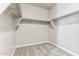 Walk-in closet featuring a carpeted floor and metal clothes rails at 5844 E Covey Ln, Phoenix, AZ 85054