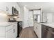 Modern kitchen with white cabinets, stainless steel appliances, stylish backsplash and tile flooring at 5844 E Covey Ln, Phoenix, AZ 85054