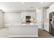 Bright kitchen with white cabinets, a center island, stainless steel appliances and tile flooring at 5844 E Covey Ln, Phoenix, AZ 85054