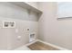 This practical laundry room features a shelf and connections for a washer and dryer, plus tiled floor at 5844 E Covey Ln, Phoenix, AZ 85054