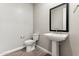 This modern powder room boasts a pedestal sink and toilet on top of stylish tile floor at 5844 E Covey Ln, Phoenix, AZ 85054