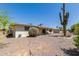 View of the backyard showcasing desert landscaping and the home's exterior at 6027 E Ellis St, Mesa, AZ 85204