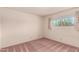 Bedroom with carpet flooring, a bright window, and neutral paint at 6027 E Ellis St, Mesa, AZ 85204